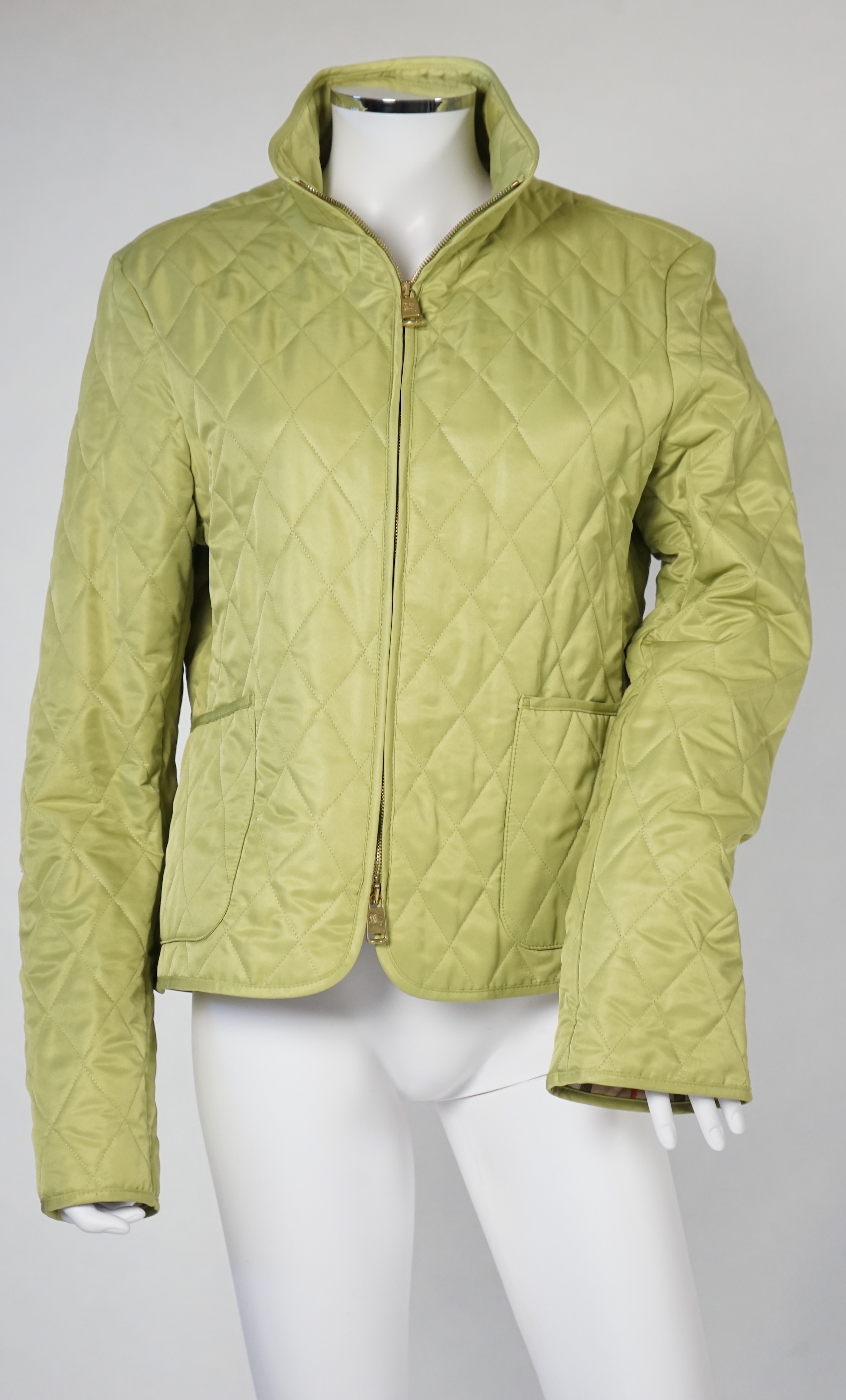 Two Burberry lady's quilted jackets, one pink and the other green, size Medium